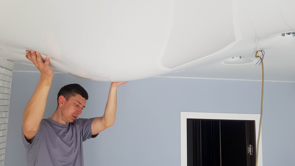 man holding bulging ceiling