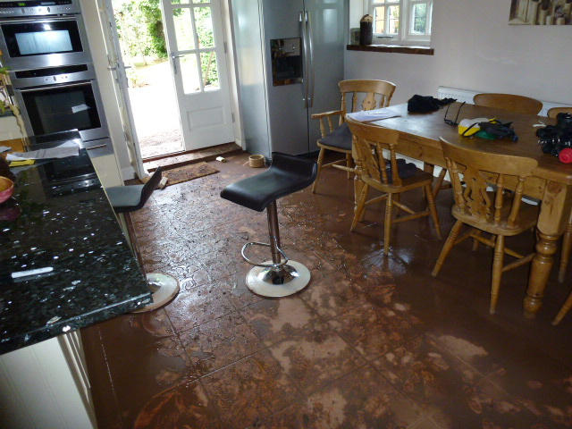 Kitchen floor and contents covered in silt following severe domestic flooding