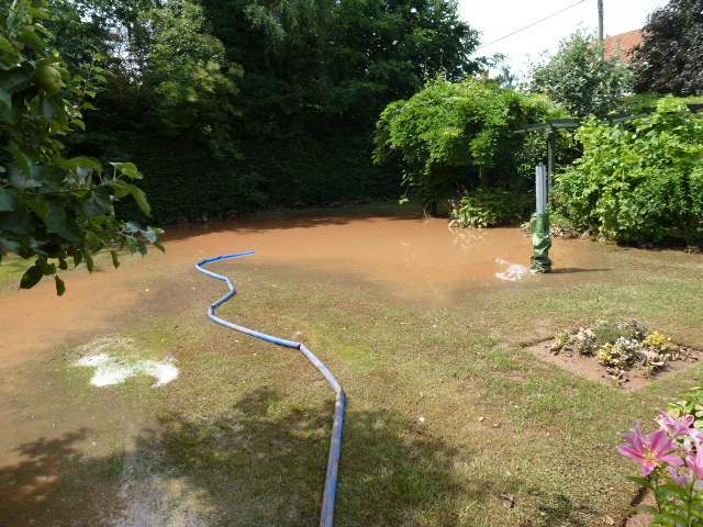 Floodwater being pumped from a domestic property during Restorations UK flood restoration