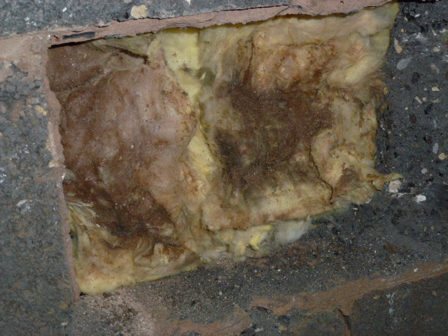 Saturated cavity wall insulation exposed following severe domestic flood damage