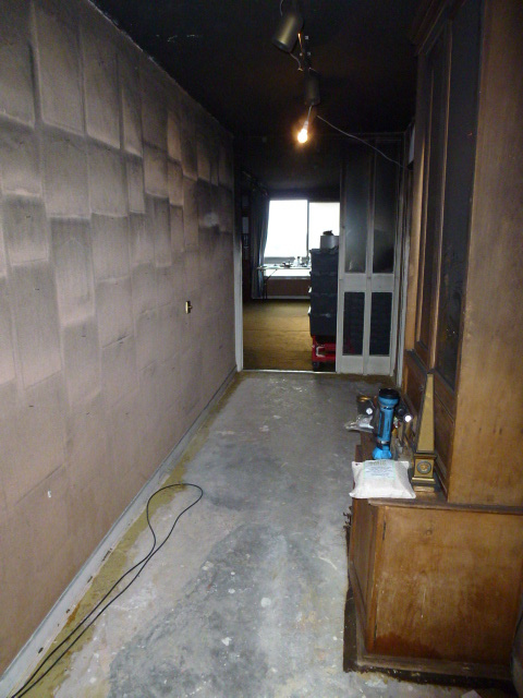 Hallway walls and surfaces heavily contaminated by smoke and soot after a fire