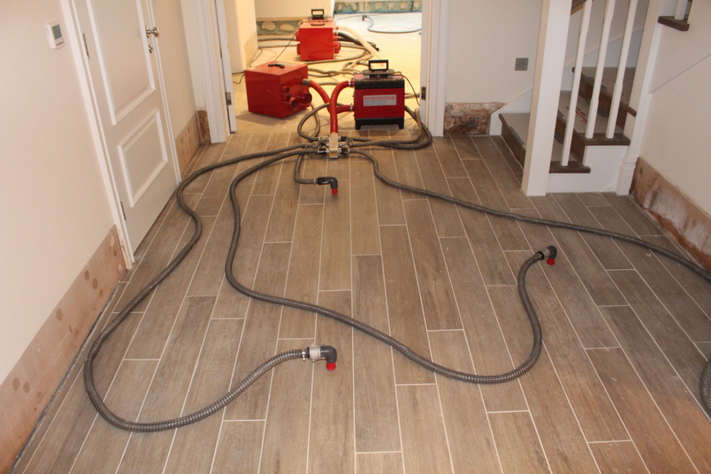 Restorations UK push-pull drying hoses connected across the floor of a luxury property