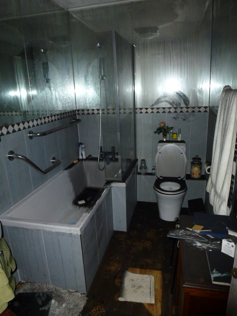 Bathroom surfaces contaminated by smoke and soot before specialist cleaning